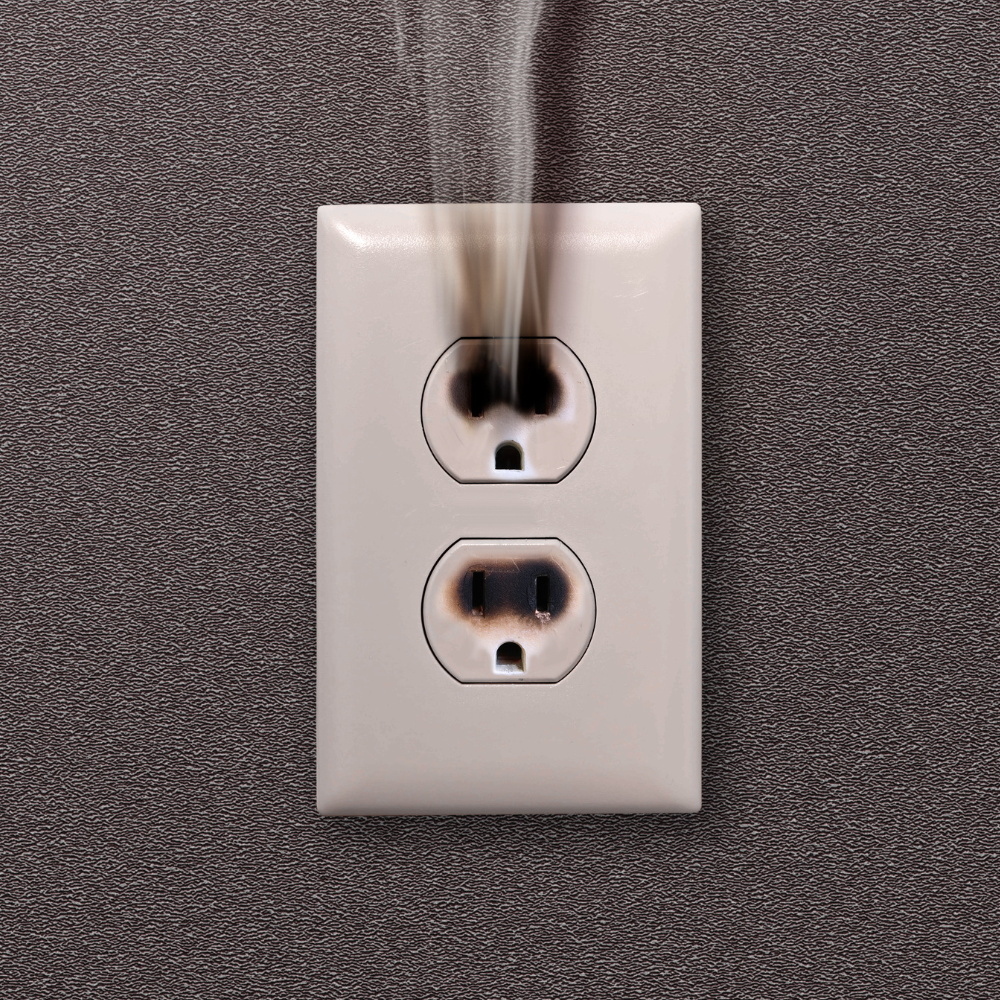Burnt electrical outlet warning sign